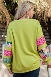 Plus size patchwork sweatshirt showing side splits and relaxed shift fit