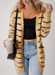 Beige pom pom cardigan showing relaxed open front shift silhouette