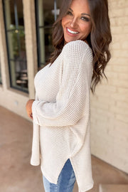 White long sleeve waffle top with subtle side slits detail