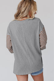 Colorblock striped top featuring regular length and bishop sleeves