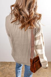 Cable knit sweater showing colorblock detail and relaxed drop-shoulder fit