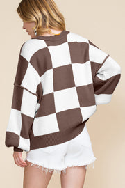 Brown and white checkered knit sweater with bishop sleeves, shown from back on model