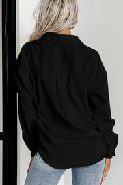 Houndstooth patchwork shacket showing flap chest pockets and relaxed shift silhouette