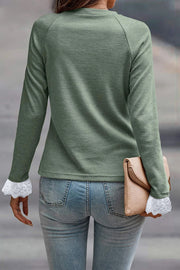 Raglan long sleeve top featuring delicate lace contrast cuffs