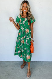 Green floral midi dress showing flowing tiered skirt movement