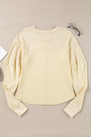Beige crew neck patchwork top styled for casual everyday layering