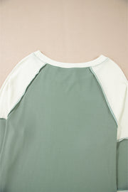 Mint green long sleeve top styled tucked into jeans