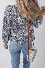 Blue floral blouse showing notched V neckline that frames the collarbone