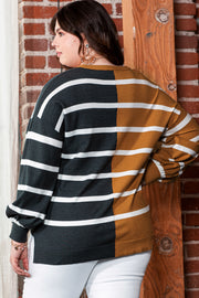 Back view of a plus size colorblock striped loose top in black and mustard, worn by a person against a brick wall