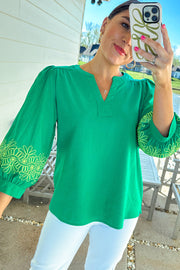 Notched V-neck blouse with contrast floral embroidery detail