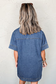 Collared denim mini dress showing patched chest pockets and V-neckline