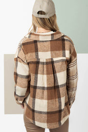 Beige plaid shacket showing double flap pockets and relaxed shift silhouette