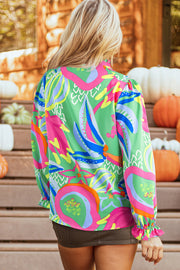 Abstract print V-neck blouse showing button detail accents