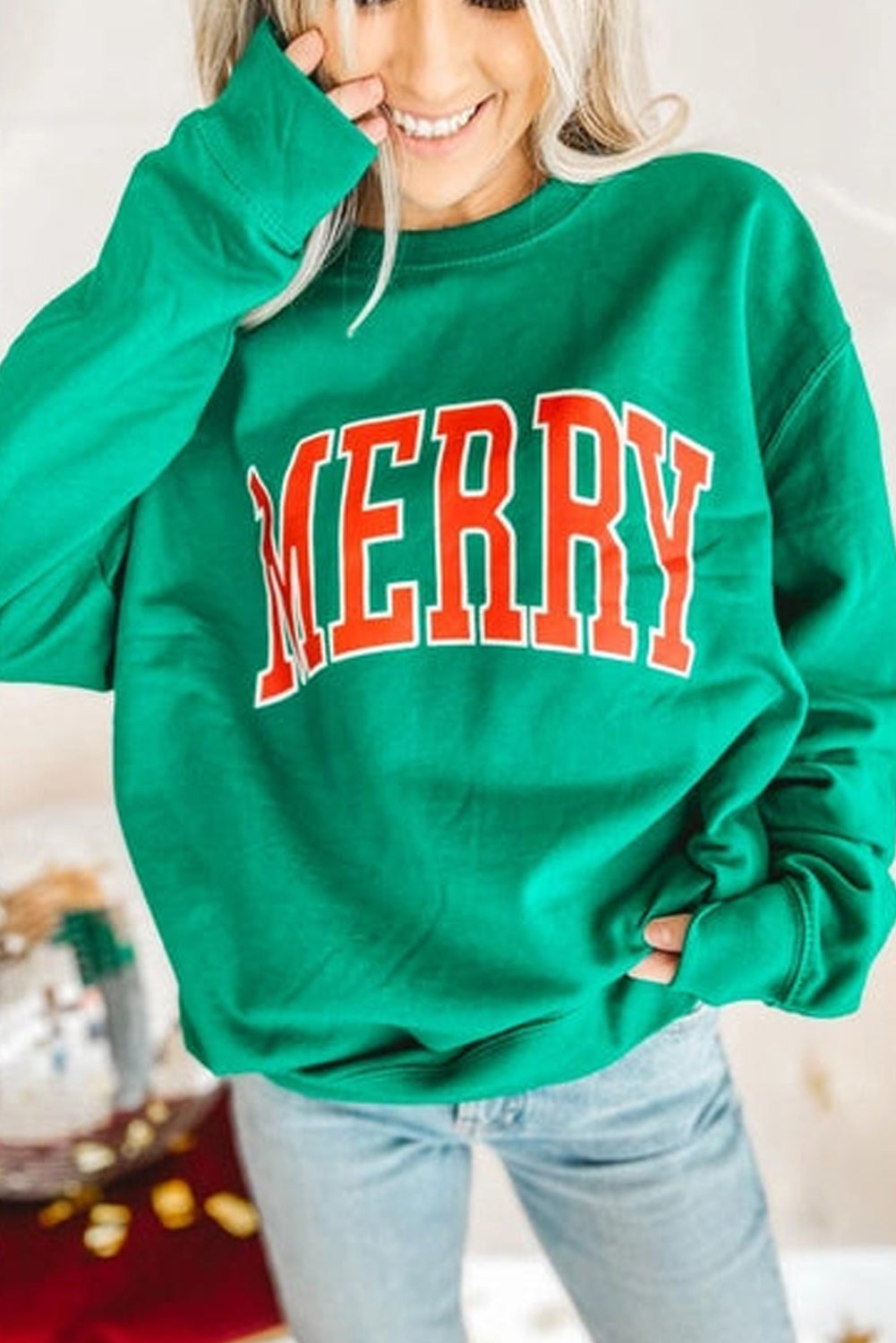 Bright green MERRY graphic pullover sweatshirt with bold festive lettering and crew neck
