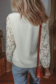 Scalloped V-neckline lace blouse showing embroidery detail throughout