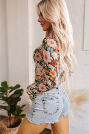 Orange floral mesh crop top showing slim sheath fit
