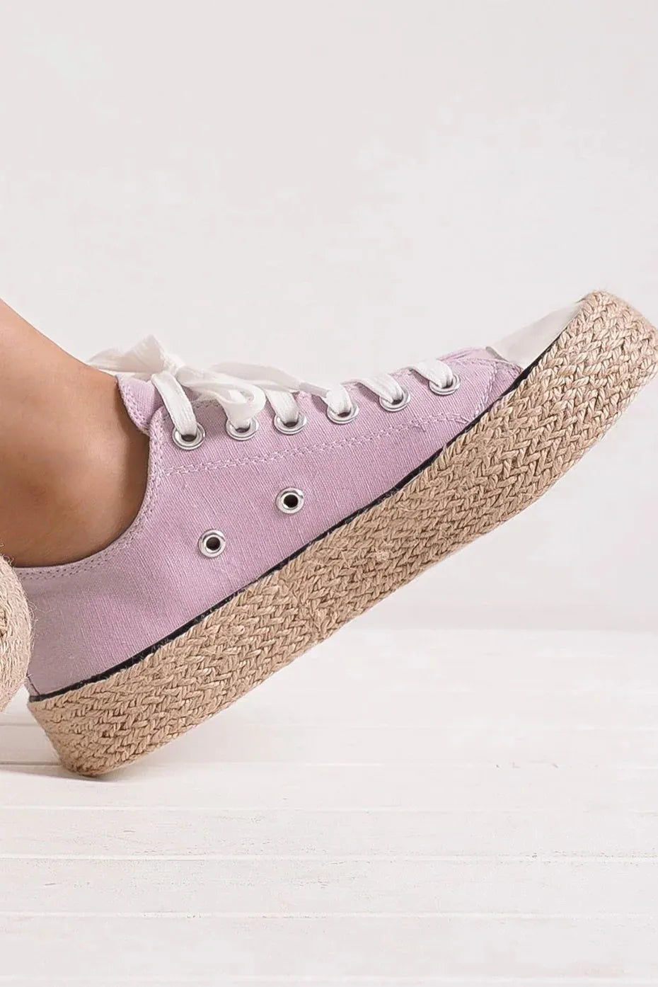 Light purple lace-up sneaker with woven espadrille sole, shown on foot at an angle