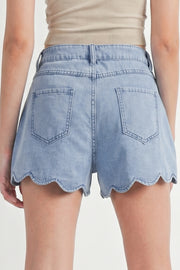 Light blue denim shorts with scalloped hem, shown from back on person wearing beige top