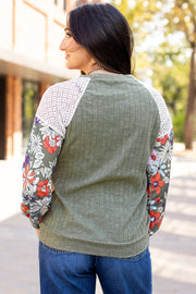 Ribbed knit blouse showing soft textured fabric with medium-high stretch