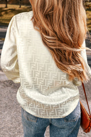 Jacquard bishop sleeve blouse showing flattering V neckline detail