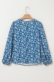 Blue ditsy floral blouse styled with long lantern sleeves