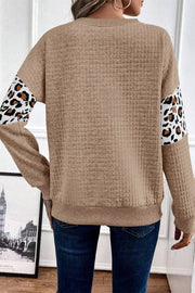 Leopard quilted sweatshirt showing soft textured fabric and round neckline
