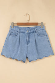 Light blue denim shorts with scalloped hem, front view on wooden hanger