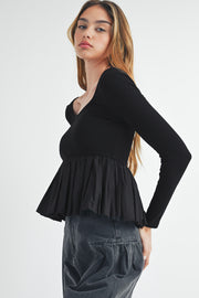 Ribbed knit scoop neck top showing flared peplum hem