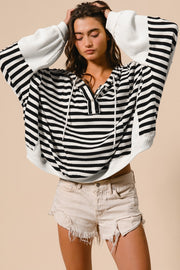 Oversized striped waffle knit top with relaxed shift silhouette and raw hem