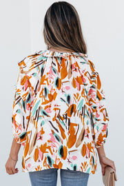 Abstract print blouse showing flattering V-neckline with frilled accents